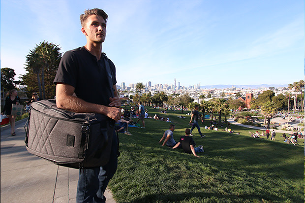 Guy with paq bag in duffle mode in park