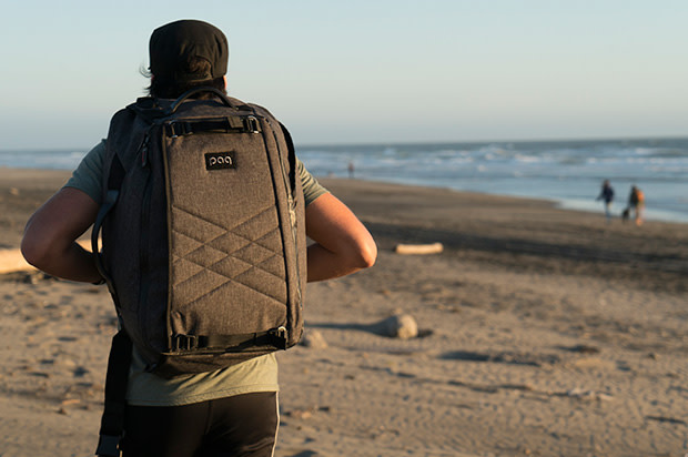 Guy walking on the beach with the paq bag