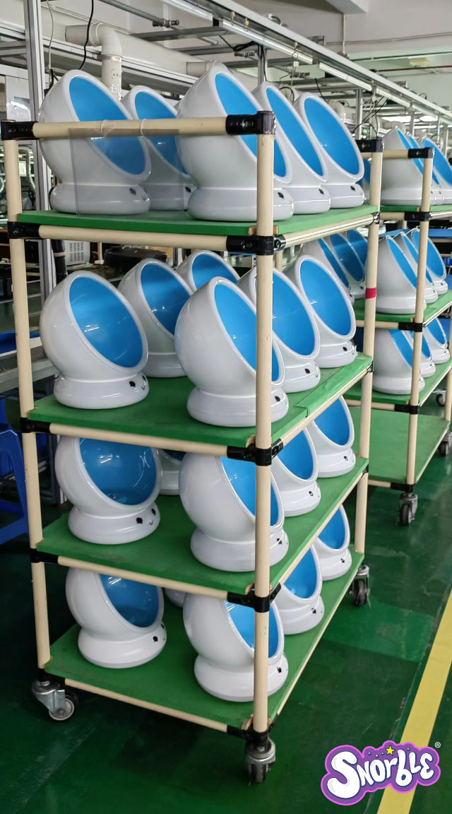 Image contains a photo of multiple Snorble® bases being prepared for testing at a factory.