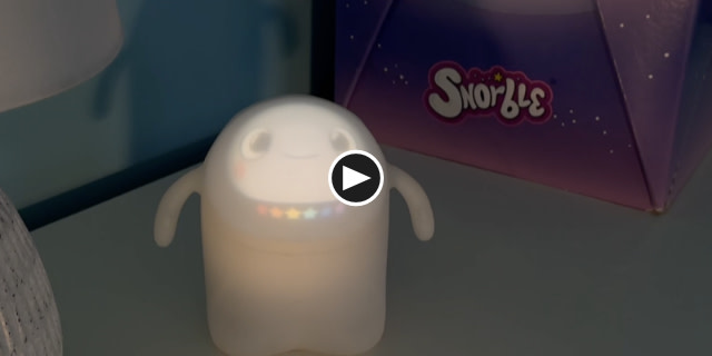 Image contains a photo of Snorble® with six stars below their face. In the center of the image, there is a play button.