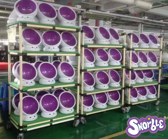 Image contains dozens of LullaPods on shelves in a factory in China.