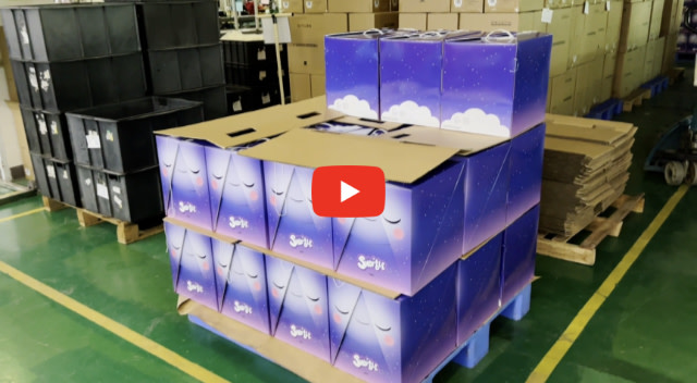 Image contains a photo of a pallet of Snorble® boxes sitting in a factory.