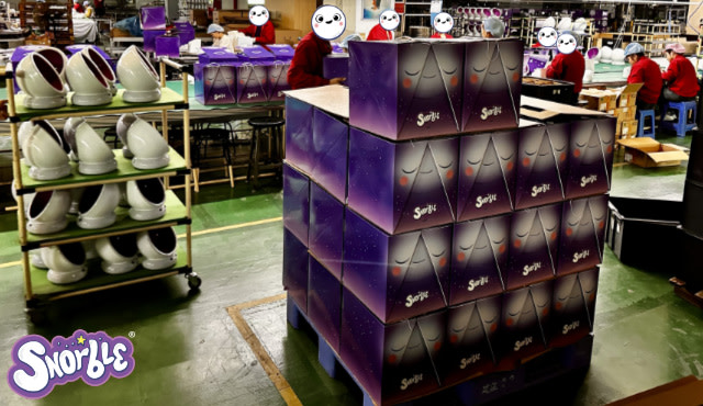 Image contains a shot from the Snorble® factory with boxes, LullaPods, and more on shelves.
