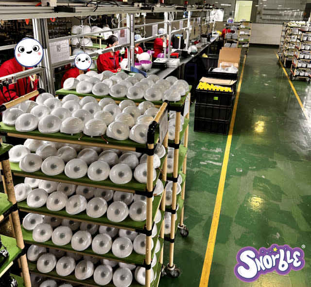 Image contains a photo from the factory of Snorble® components on shelves.