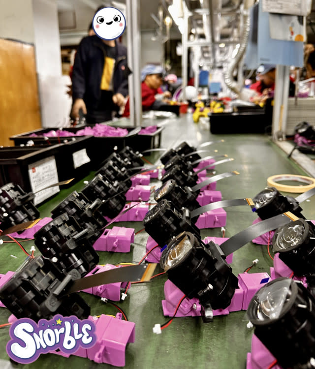 Image contains a photo from the factory of Snorble's projector lenses.