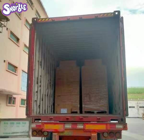 Image contains a photo of pallets of Snorbles® in a container truck.